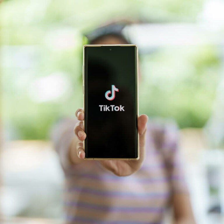 Osoba trzymająca telefon z wyświetlonym TikTokiem