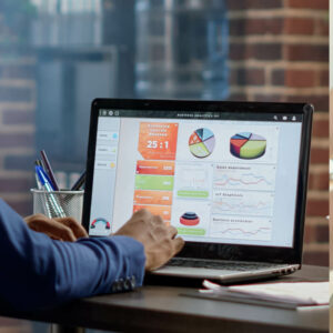 Pracownik analizujący wyniki sprzedaży na laptopie